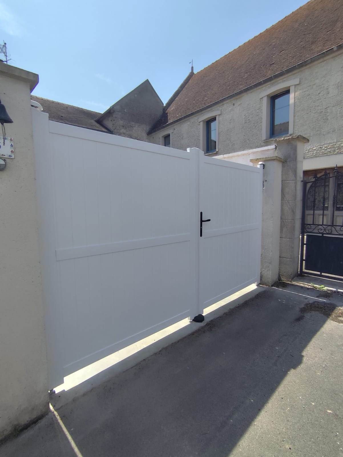 Nouveau portail blanc installé devant une maison — photo après